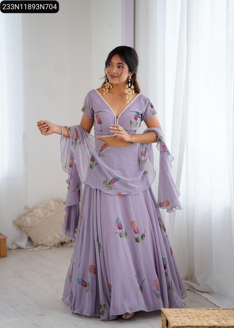 Model wearing a lavender pure georgette hand-painted lehenga choli set with dupatta, standing gracefully by a window.