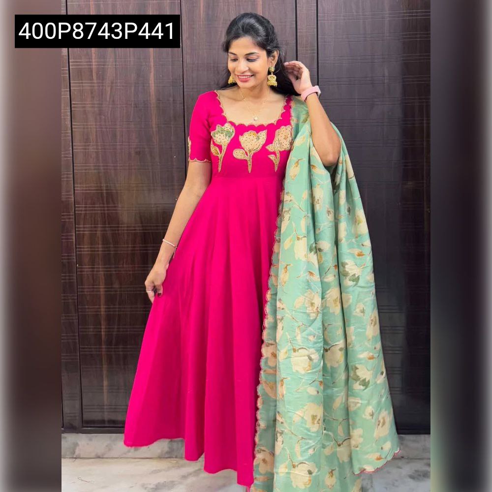 Full shot of a model in a hot pink TRENDBUY Vichitra silk anarkali gown with golden floral maggam work, paired with a mint green floral chinon dupatta.
