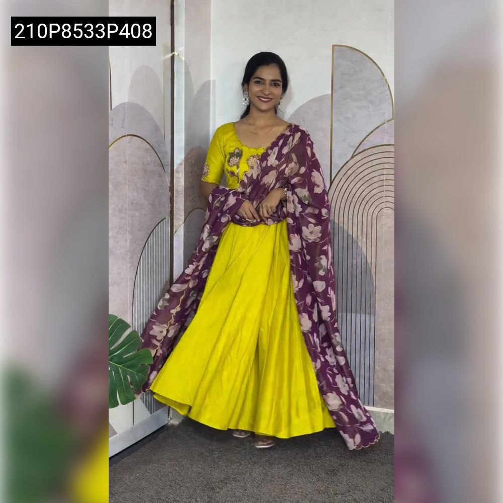 Model gracefully posing in a bright Yellow TRENDBUY Vichitra Silk gown with exquisite hand-painted Maggam work and a rich purple floral Chinon dupatta.