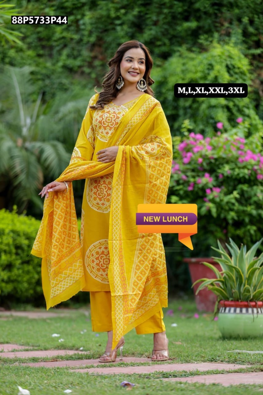 Smiling model in a full shot, wearing TRENDBUY Mustard Yellow cotton kurti set with bandhani print and flowing dupatta, outdoors