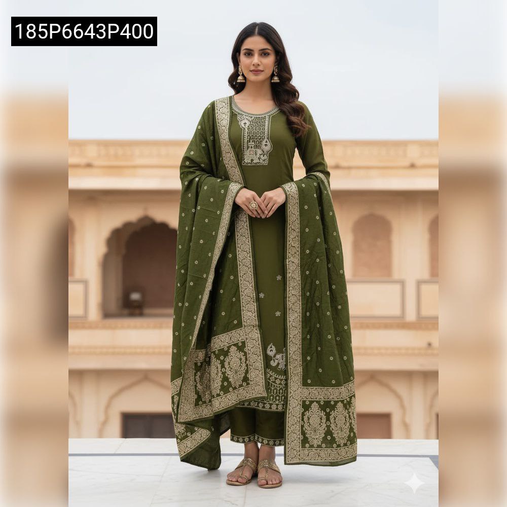 TRENDBUY model in olive green hand work kurti set with dupatta and pants, standing against a traditional building.
