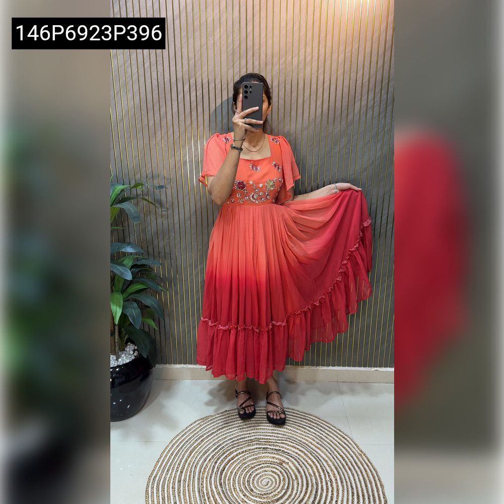 Full-length model posing in a flowing TRENDBUY ombre coral red hand-embroidered ruffled georgette midi dress, showcasing its flair.