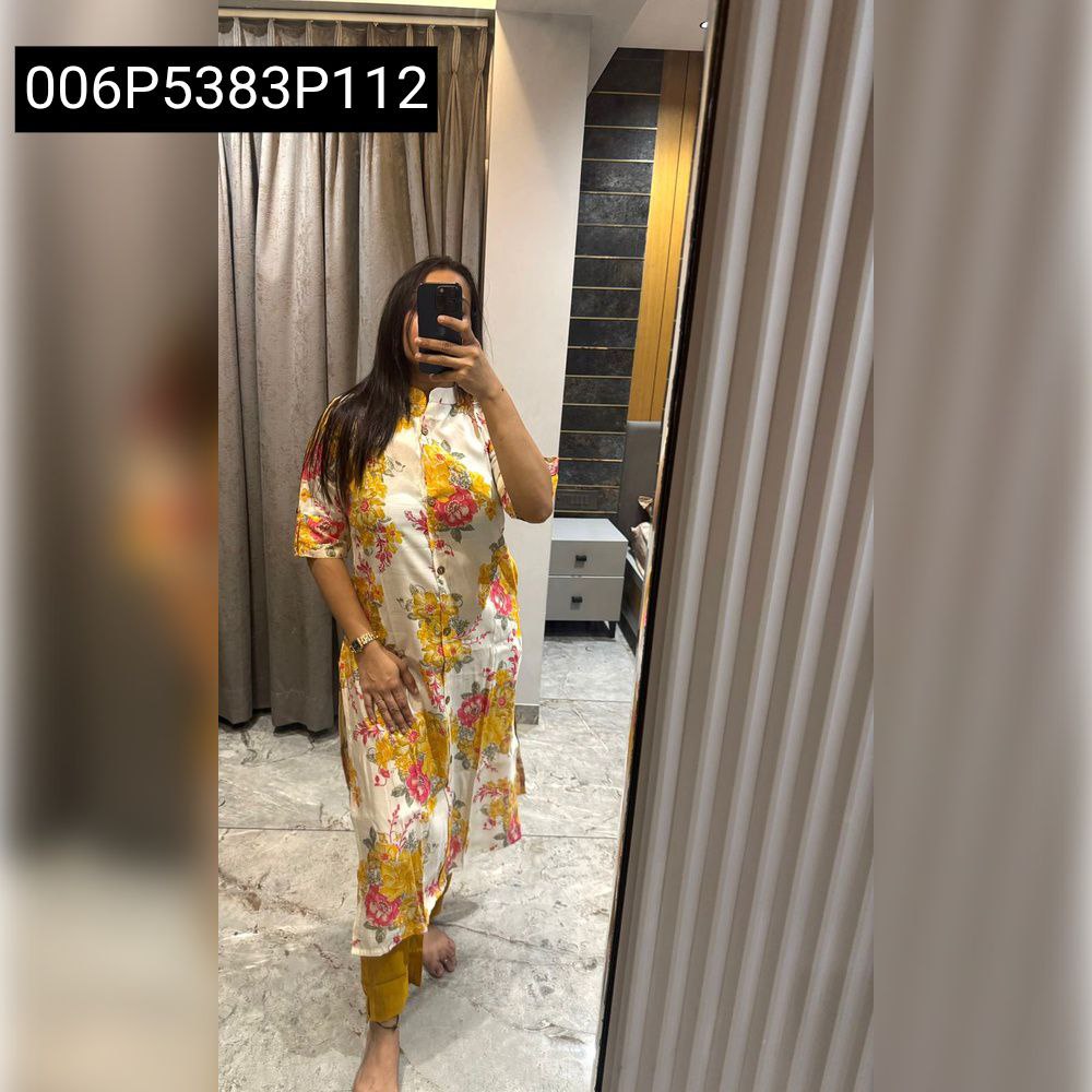 Model in white, yellow, and pink floral print bamboo cotton kurta set with yellow pants, posing for a mirror selfie.