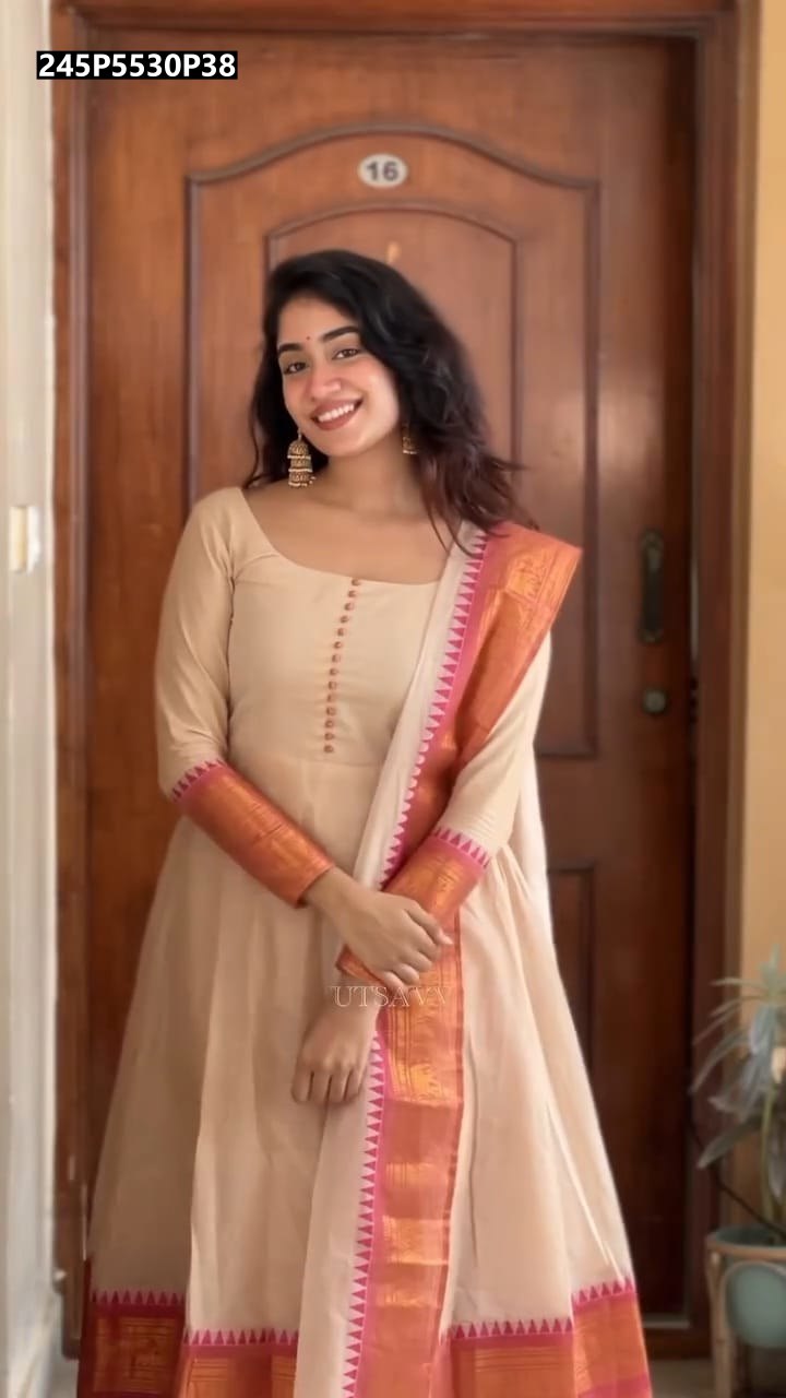 TRENDBUY Cream Pure Cotton Anarkali Suit with peach and gold border dupatta, model smiling, full shot