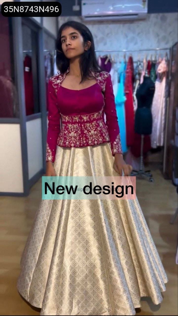 TRENDBUY model showcasing a vibrant magenta chinon choli with heavy gold embroidery and a cream jacquard lehenga, full body shot