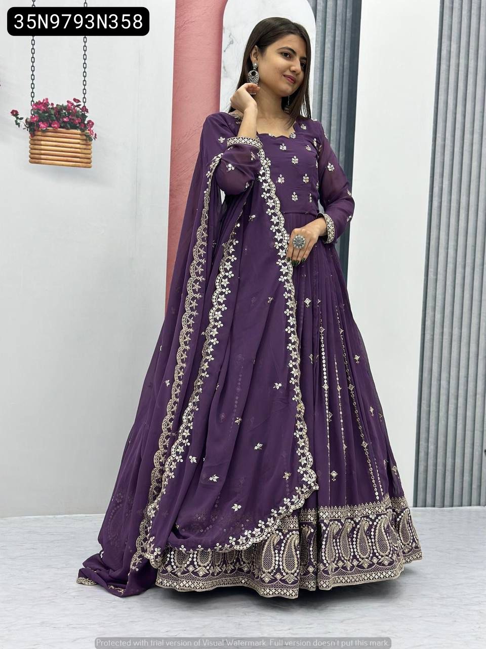 Elegant model posing in a full-length lavender purple Fox Georgette gown, heavily embroidered with gold sequins, paired with a matching dupatta.