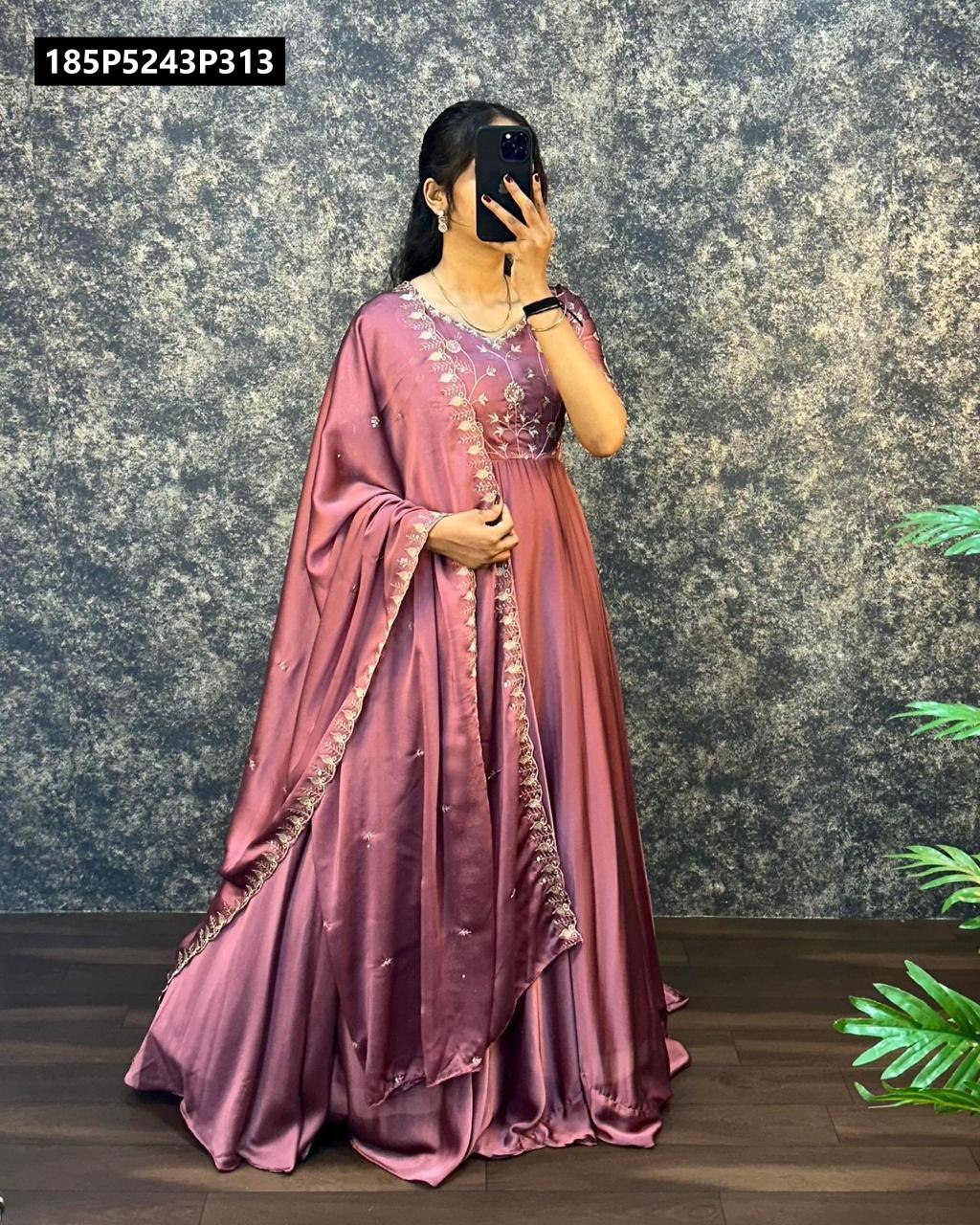 Full body shot of a model wearing a luxurious dusty plum satin chiffon gown with intricate embroidery and a matching border-embroidered dupatta.