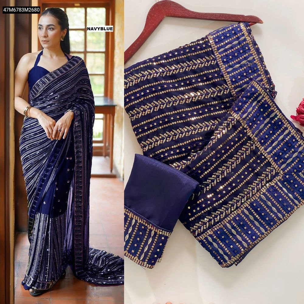 Model in Navy Blue TRENDBUY Faux Georgette Saree with sequins, alongside the folded saree and blouse piece.