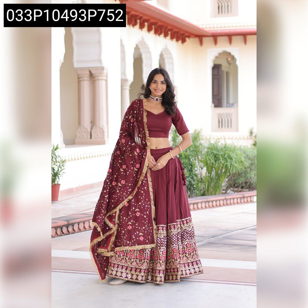Model in a vibrant maroon Vichitra silk lehenga choli with heavy sequin and thread embroidery, standing full body with a joyful expression, dupatta gracefully draped.