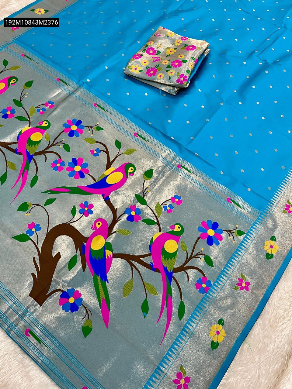TRENDBUY Aqua Blue Heavy Soft Silk Saree with silver zari weaving, vibrant parrot pallu, and floral border. Flat lay with matching brocade blouse.