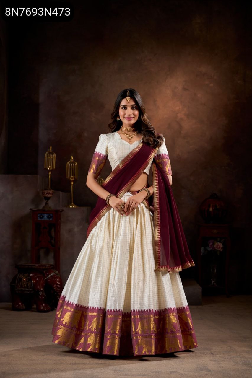 Full shot of a smiling model showcasing the TRENDBUY Kalyani Cotton Lehenga Choli in cream and maroon with intricate zari weaving.
