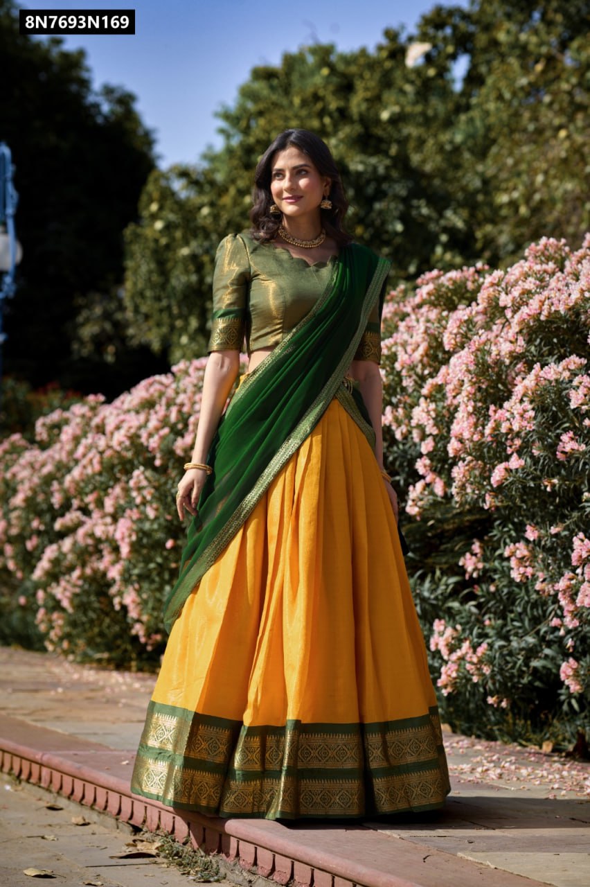 Full shot of a model elegantly standing in a traditional Kanchipuram green and yellow lehenga choli by TRENDBUY, adorned with fine zari weaving and a flowy green georgette dupatta, perfect for festive occasions.