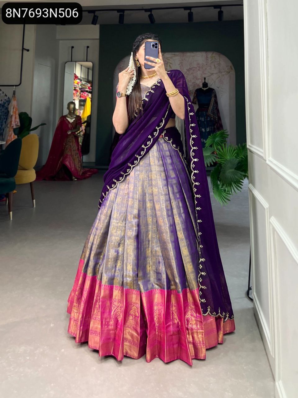 Full shot of model showcasing TRENDBUY Kanjivaram silk lehenga choli with purple dupatta, grey lehenga, and vibrant pink border.
