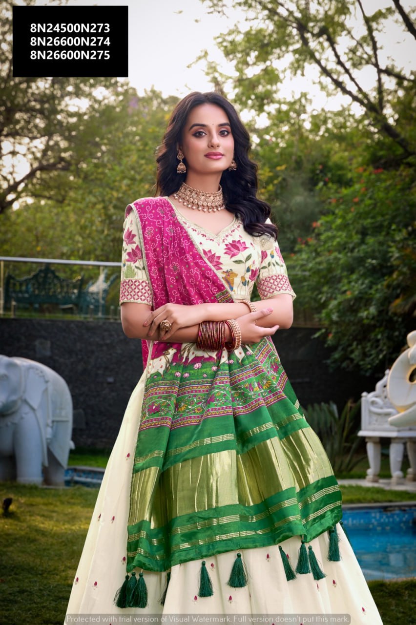 TRENDBUY woman in off-white Khadi Cotton lehenga choli with vibrant pink and green Gaji Silk dupatta, intricate sequins and thread embroidery, standing elegantly in a garden.