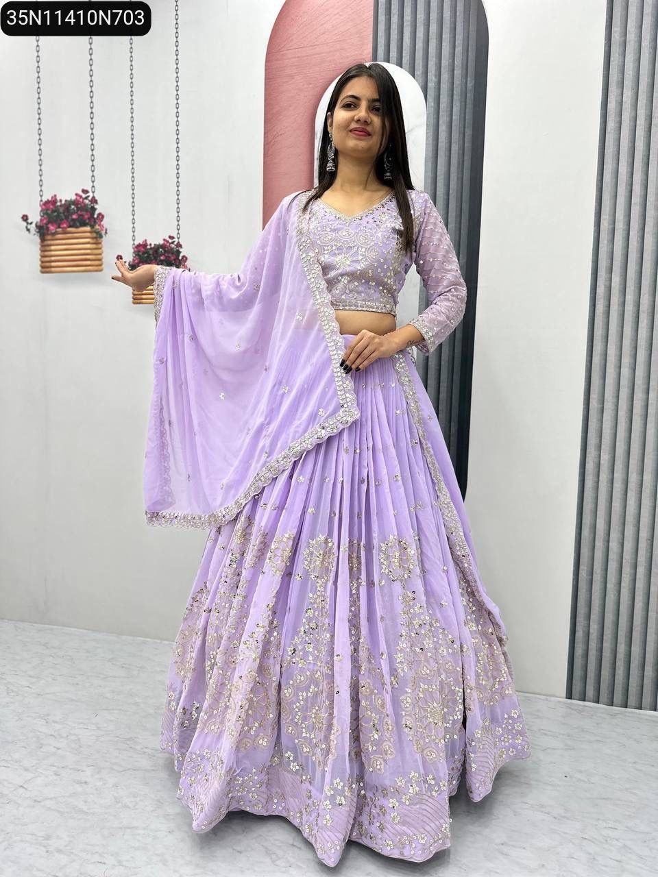 Model in a studio, posing to showcase the full flair and design of the TRENDBUY lavender Fox Georgette embroidered lehenga choli and matching dupatta.