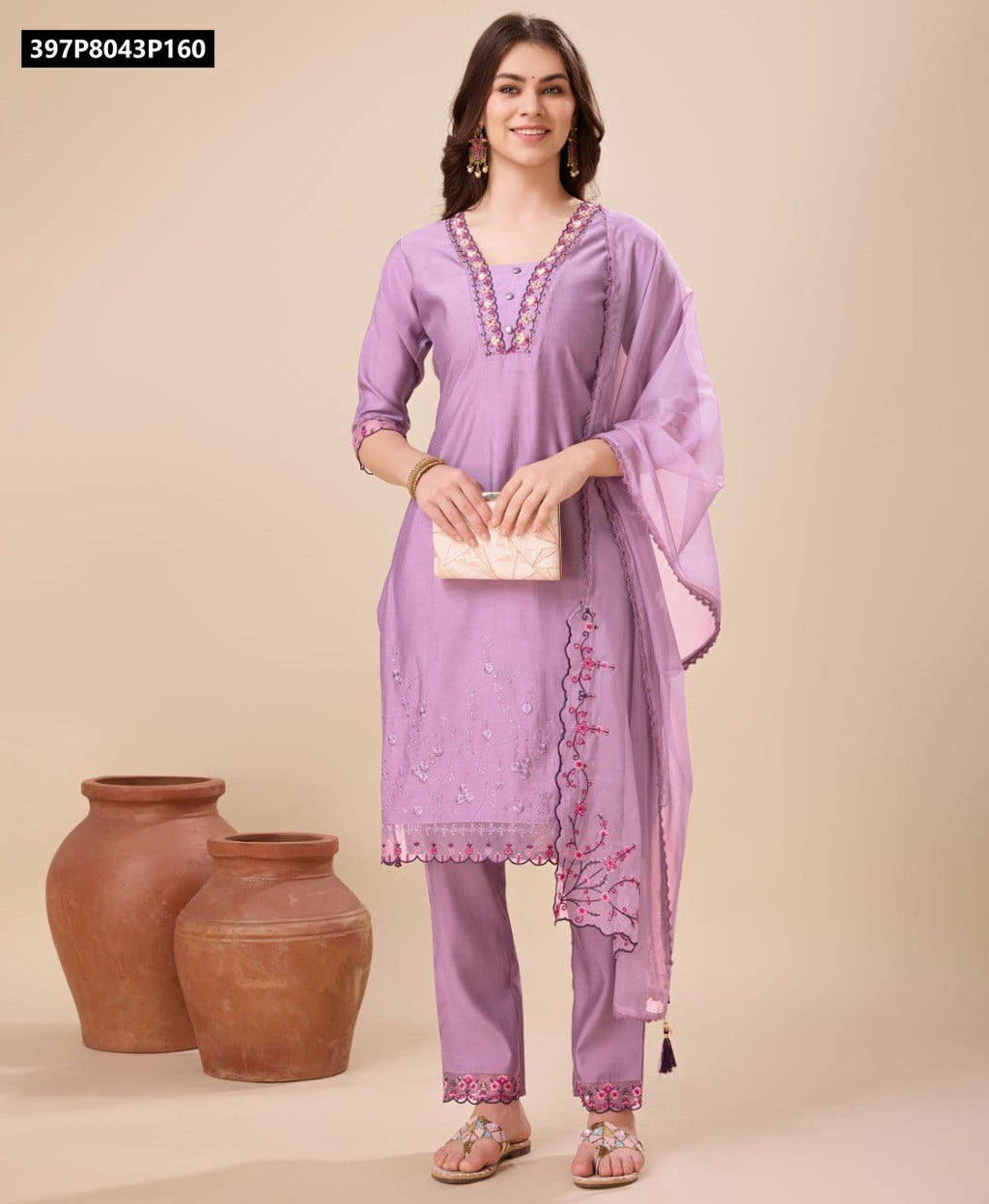 Full body shot of a smiling model wearing a lavender TRENDBUY viscose silk embroidered kurta set with dupatta, holding a clutch.