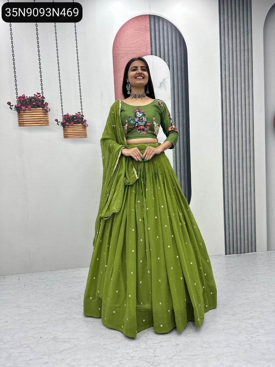 Full body shot of a smiling model wearing the TRENDBUY Lime Green Kalamkari Handwork Lehenga Choli Set, posing in a modern interior.