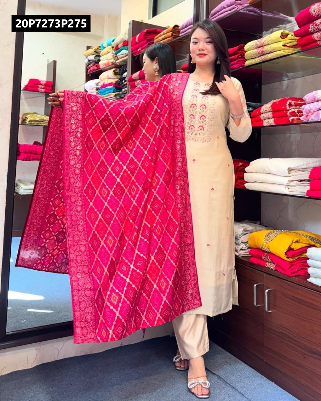 Full shot of model in cream kurti with vibrant royal pink banarasi bandhej dupatta, showcasing full outfit.