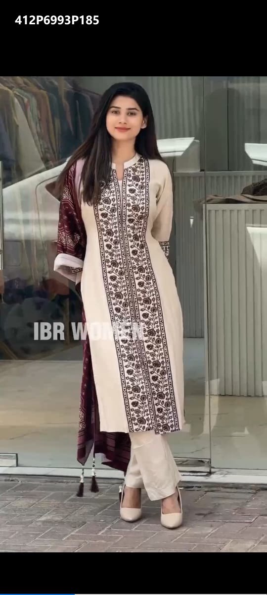 Stylish model captured in a full-length shot, showcasing the elegant off-white Chanderi Silk kurti with heavy multi embroidery and coordinating maroon dupatta and pants.