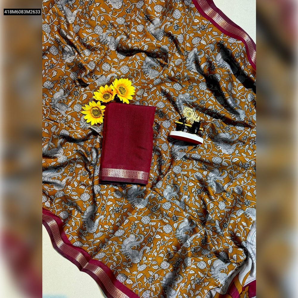 TRENDBUY Mustard Yellow Mul Mul Cotton Saree with ornate white and grey floral peacock print, featuring a maroon jacquard border and matching maroon blouse piece, presented as a flat lay with sunflowers.