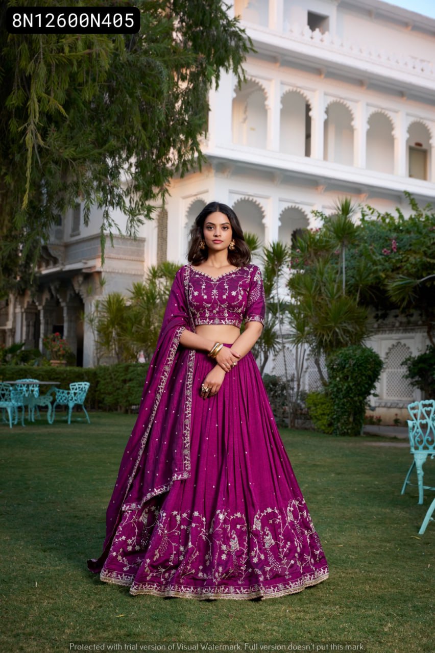 Full body shot of a beautiful model posing elegantly in TRENDBUY magenta purple Vichitra silk lehenga choli with dupatta, featuring elaborate sequin and thread embroidery, set in a traditional garden with white architecture.