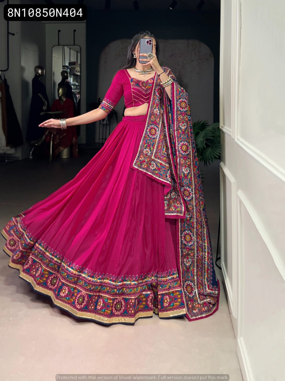 Dynamic full body shot of TRENDBUY Magenta Tasar Silk Lehenga Choli, model twirling to highlight the grand flair and detailed Gamthi printed dupatta.