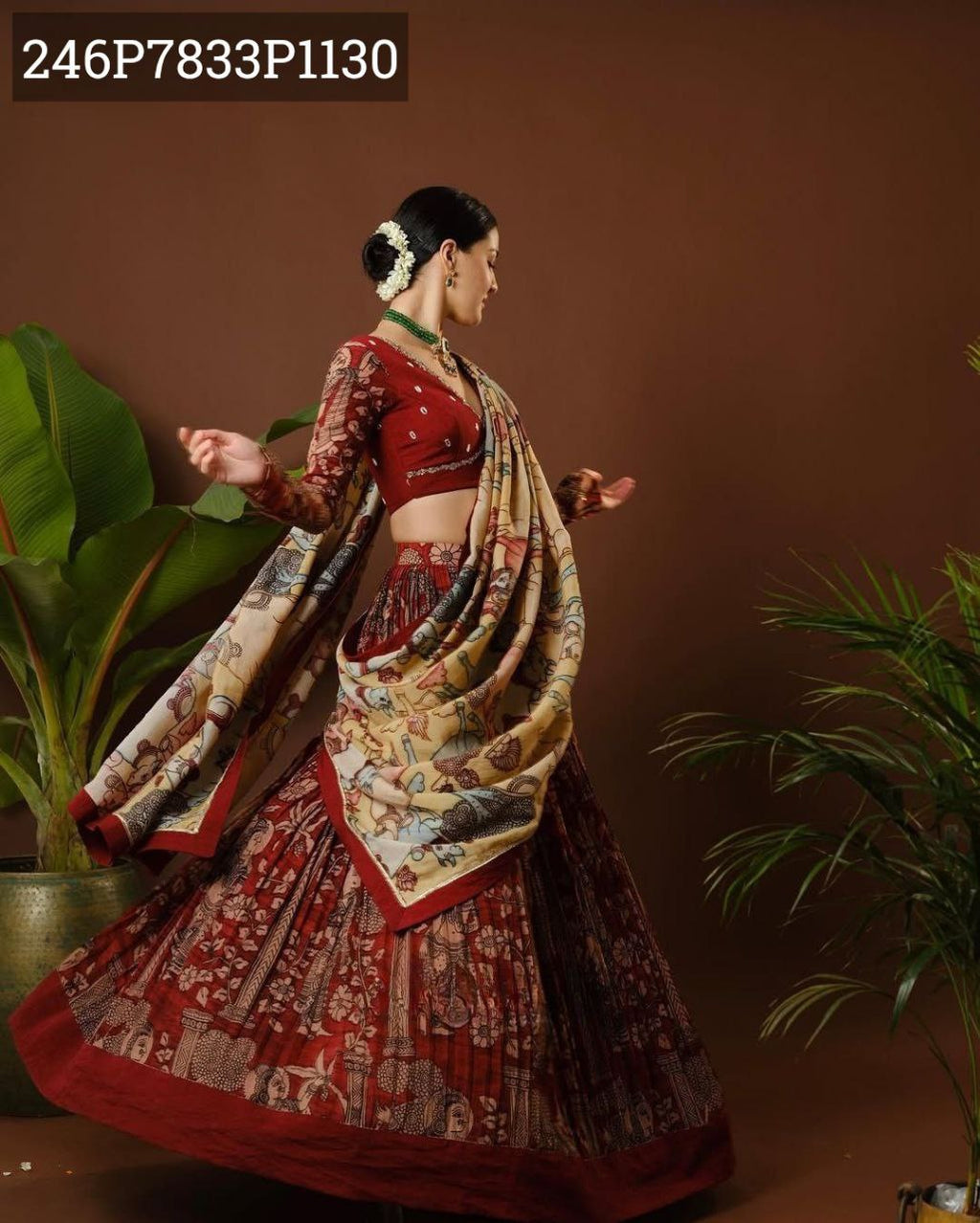 TRENDBUY model in a dynamic pose, showcasing the flowing maroon Tussar silk Kalamkari print lehenga and elegantly draped dupatta.