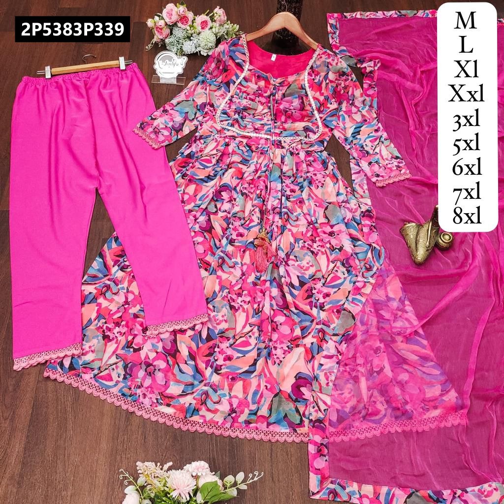 Full view of TRENDBUY multi-print pink georgette Anarkali gown with matching pants and Nazneen dupatta, laid flat on a wooden surface with floral decor.