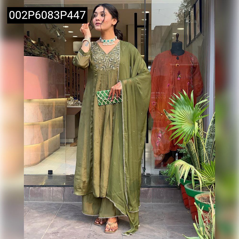 Full-body shot of the model in the complete muted green Chinon kurta, palazzo, and dupatta set, standing outdoors.