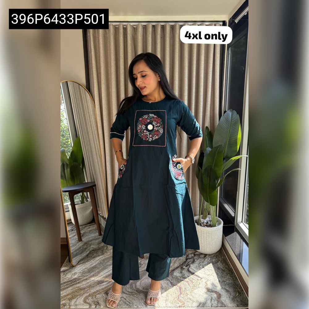 Full view of a TRENDBUY teal Natural Dhabu Cotton kurti and plazo set, featuring a prominent embroidered neck patch and double pockets, worn by a model indoors.