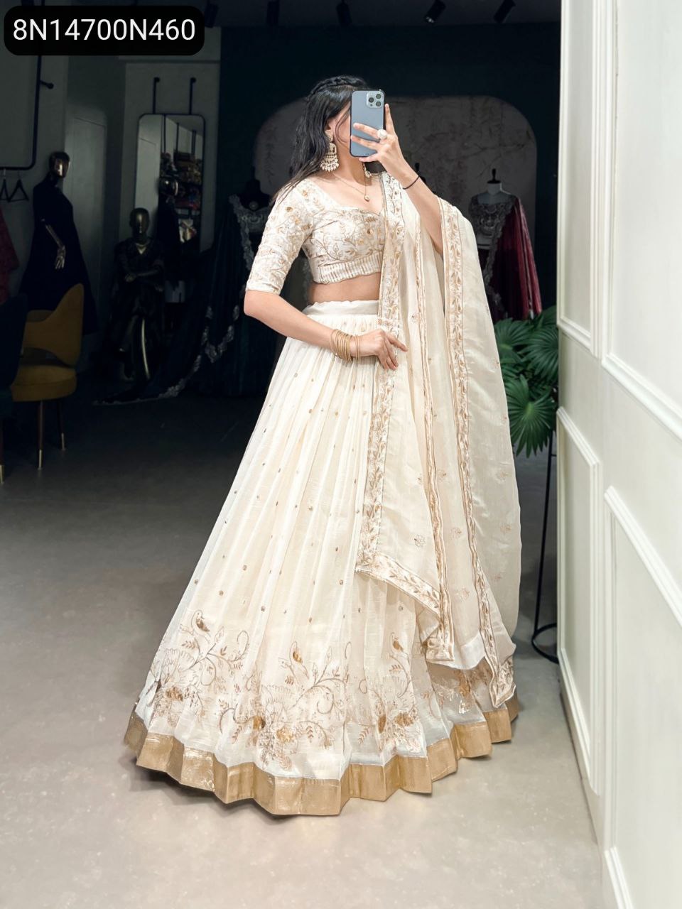 TRENDBUY Off-white sequined and embroidered lehenga choli with dupatta, model posing gracefully.