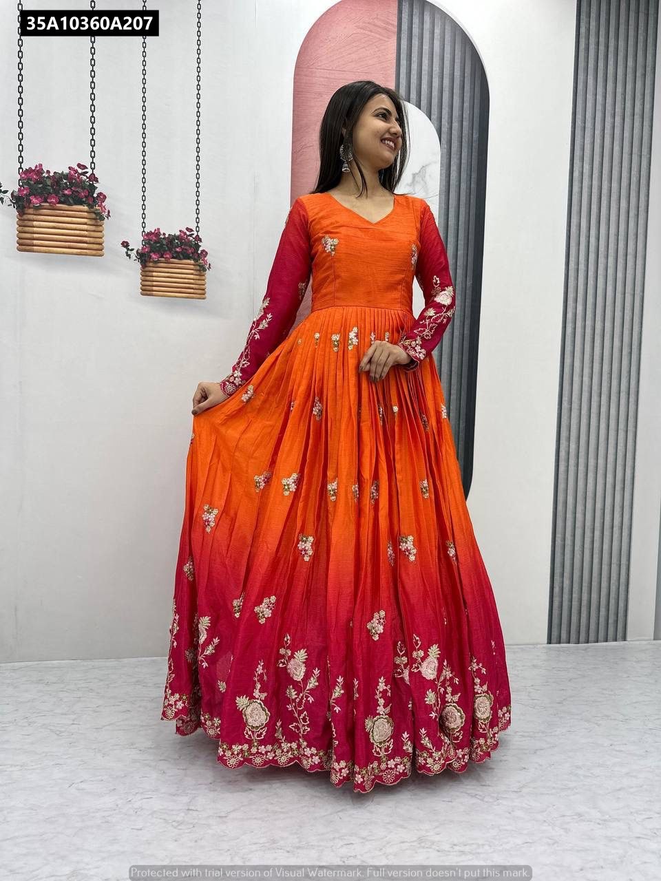 Model smiling, wearing the full-length TRENDBUY Ombre Embroidered Gown (orange to red) with green chinon dupatta.