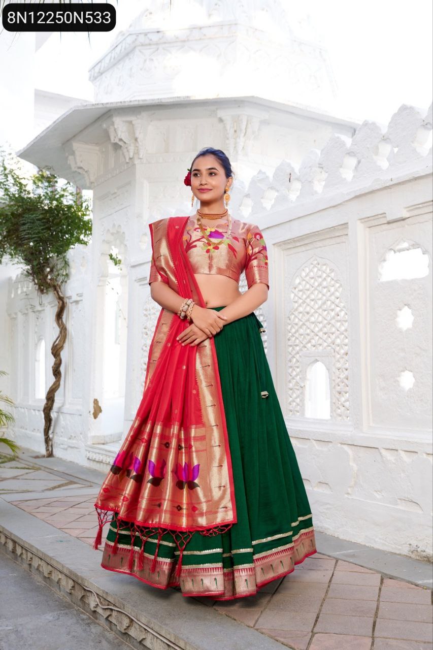 Full length shot of model in green Vichitra silk lehenga with red Paithani zari weaving dupatta and gold jacquard silk blouse, standing in front of white archways.