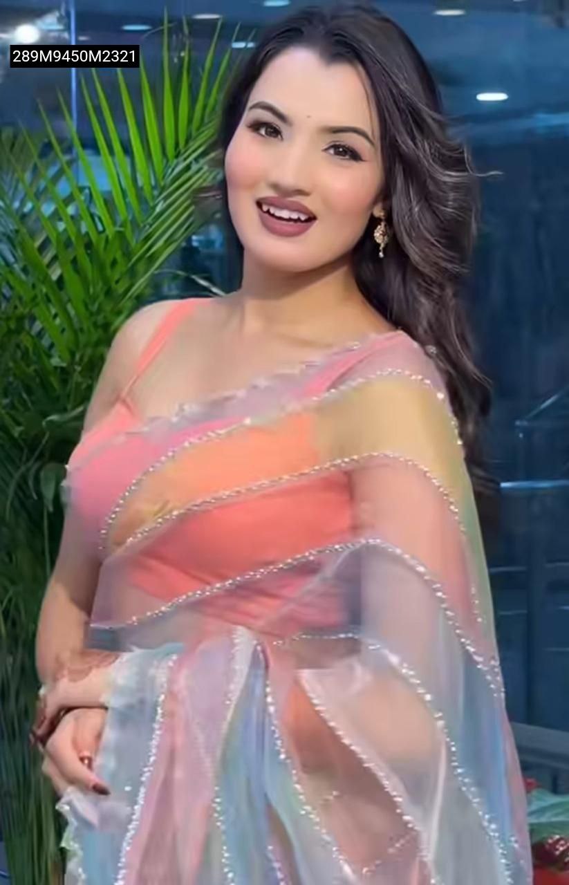 TRENDBUY model in pastel rainbow tabby organza saree, peach blouse, smiling, showing bead and katdana border.