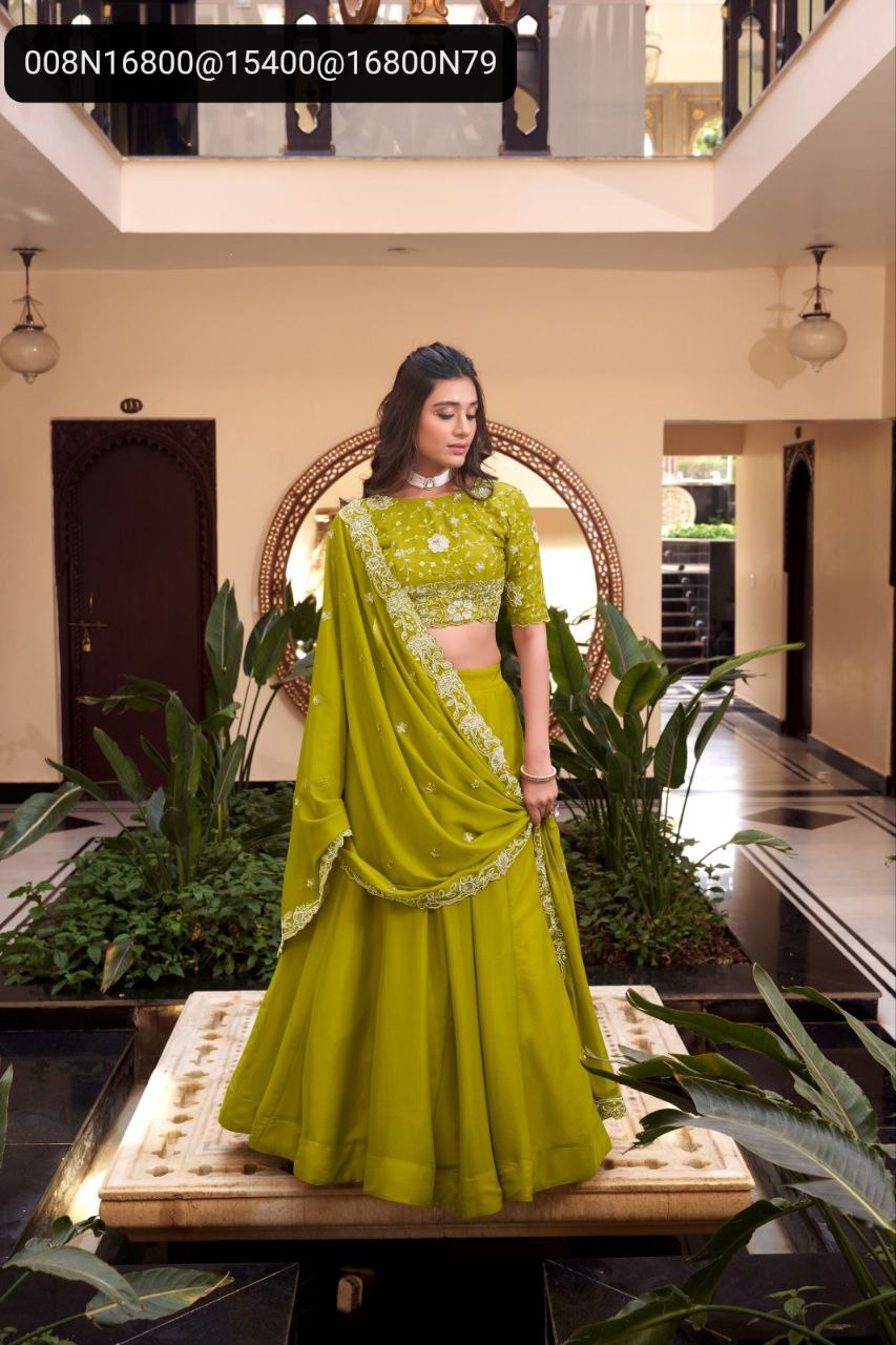 Model in elegant TRENDBUY Pista Green lehenga choli, adorned with pearl and sequin embroidery, posing gracefully in a luxurious setting.