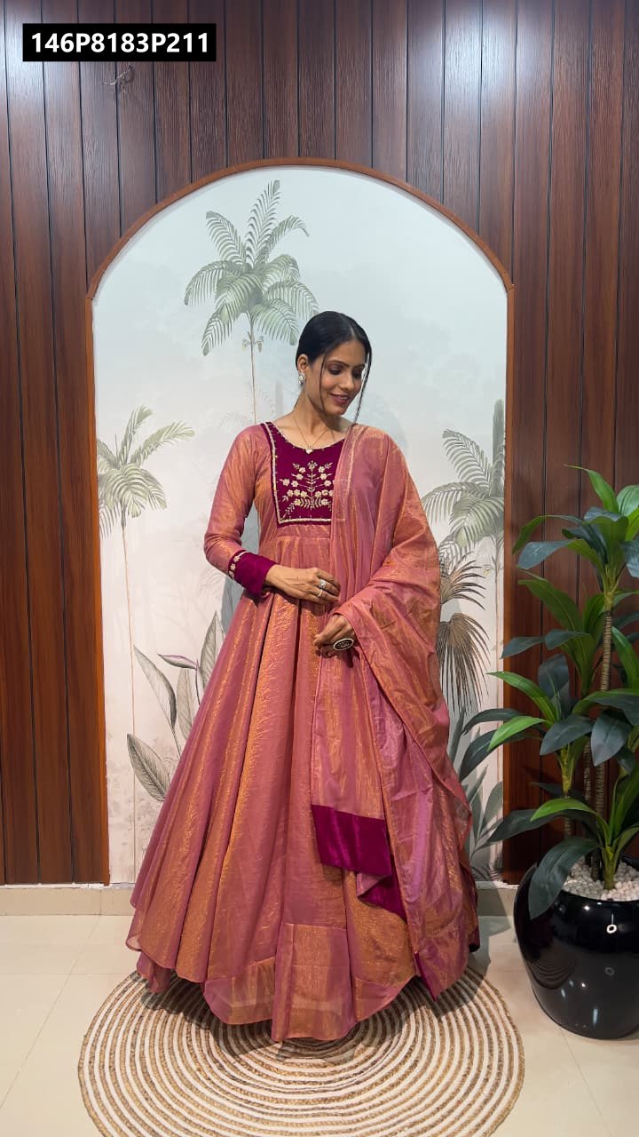 TRENDBUY model in rose pink Fendy Tissue Silk gown with maroon velvet embroidered yoke and matching dupatta, full body shot.