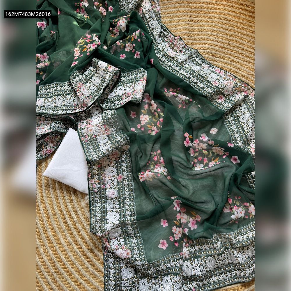 TRENDBUY Bottle Green Georgette Saree with digital floral print and heavy embroidered lace border, draped with matching unstitched blouse fabric, on a textured mat.
