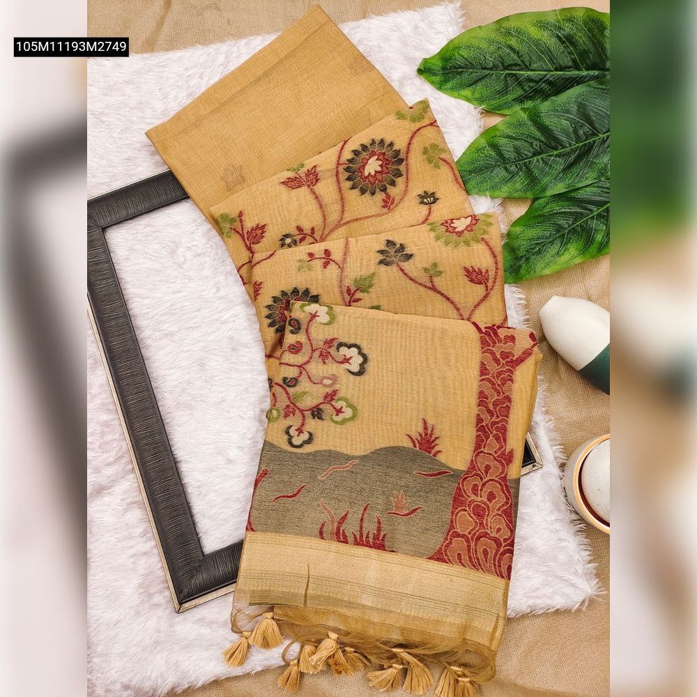 Top-down view of a folded TRENDBUY golden Muga Cotton saree with intricate floral and landscape Resham weaving, contrast border, and tassels, displayed on a white fluffy rug.