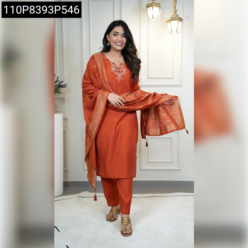 TRENDBUY model in rust Roman silk kurta set, embroidered neckline, and patterned jacquard dupatta, posing confidently.