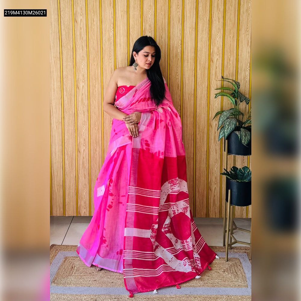 TRENDBUY model in a vibrant pink and red soft linen cotton saree with abstract batik print and silver border, posing elegantly.