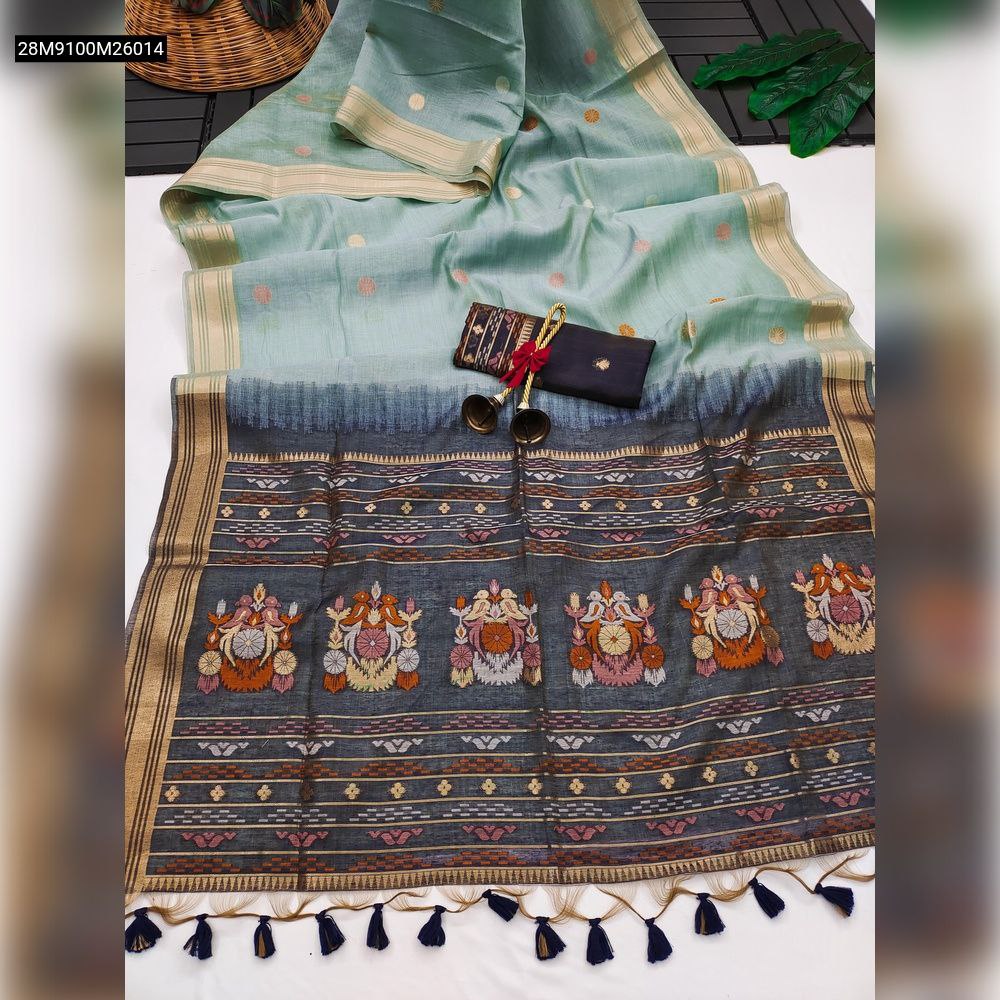 TRENDBUY Mint Green Muga Cotton Saree laid out, featuring a dark grey pallu with colorful resham parrot weaving, a traditional golden zari border, dark blue fancy tassels, and a black contrast blouse piece.