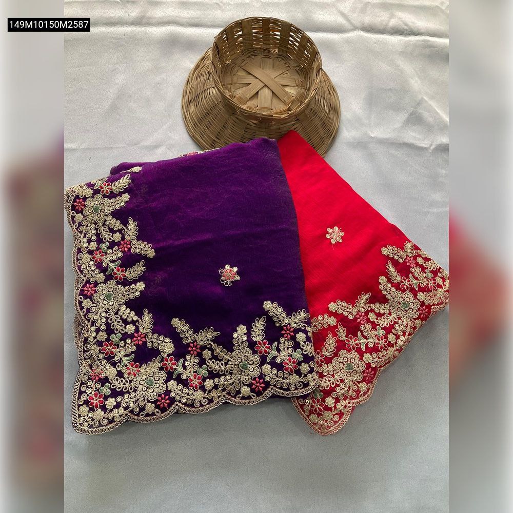 Two folded TRENDBUY Soft Space Silk Sarees in deep purple and hot pink, showcasing intricate gold and multi-color floral embroidery with a cutwork border, displayed on a light surface with a wicker basket.