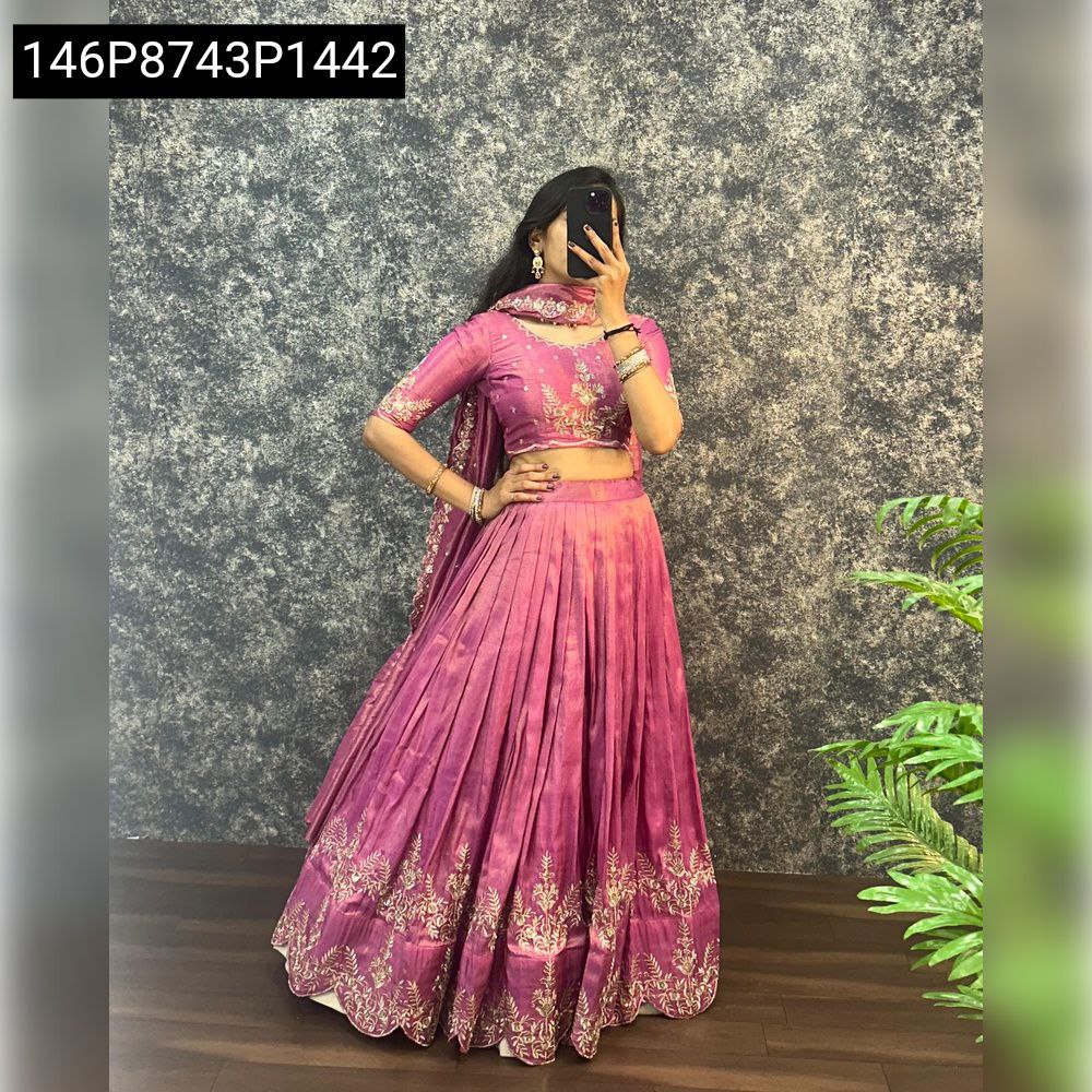 Full body shot of a model wearing TRENDBUY purple tissue silk lehenga choli, featuring a flared skirt with detailed zari work and a matching blouse and dupatta.