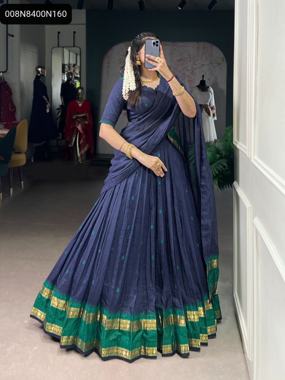 TRENDBUY Navy Blue Chanderi Half Saree Lehenga Choli with green & gold Zari border, model in a boutique.