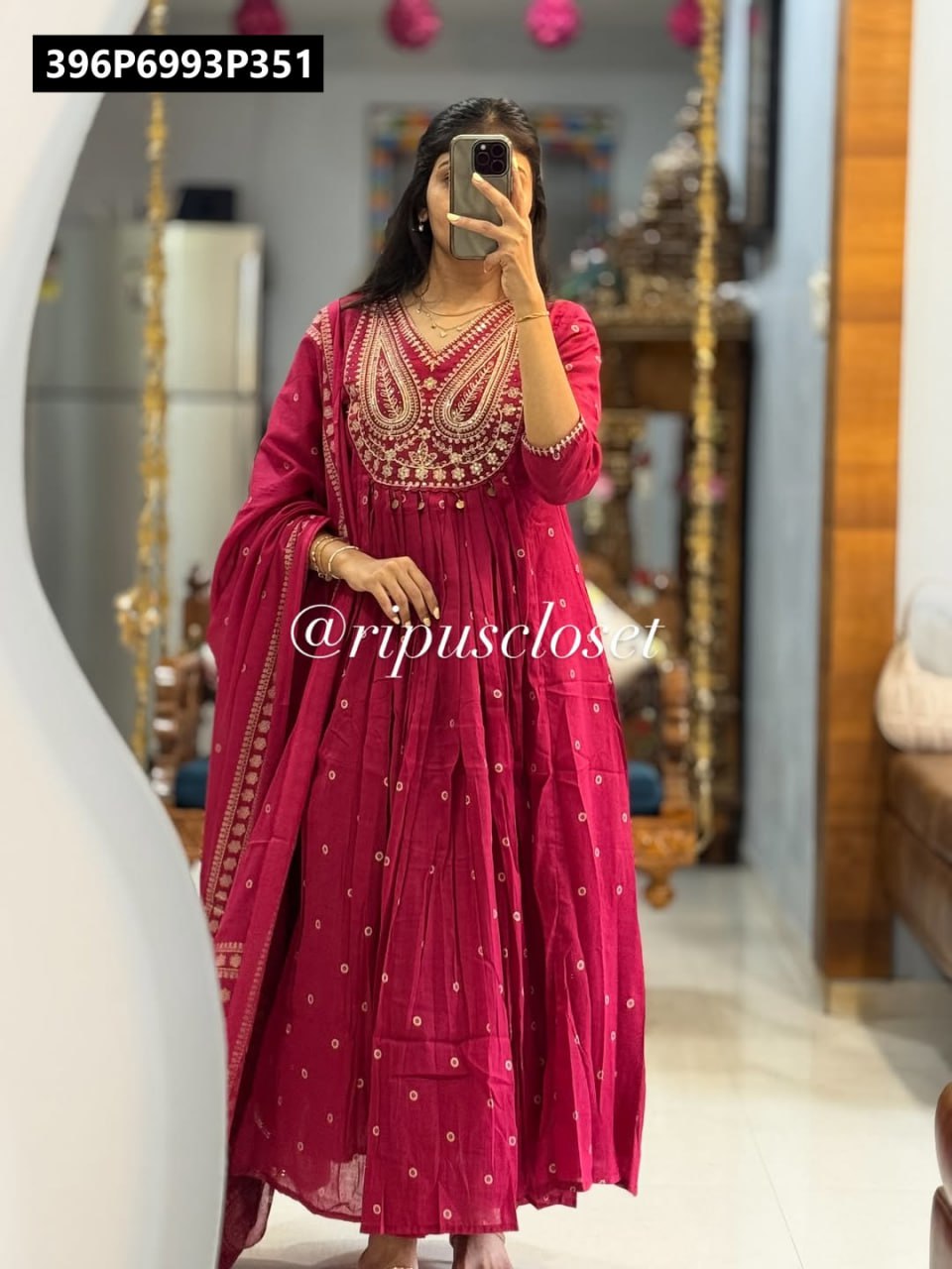 Full body model shot of a woman in a vibrant deep pink TRENDBUY pure cotton embroidered Anarkali kurta set with dupatta, reflecting in a mirror.