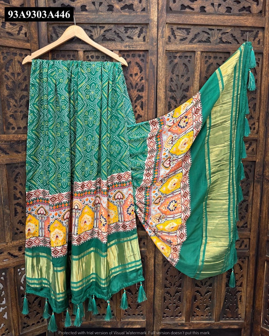 Vibrant green Pure Gaji Silk dupatta featuring intricate Bandhani print, multi-color border with Lagdi Patta, and green tassels, displayed on a wooden hanger.