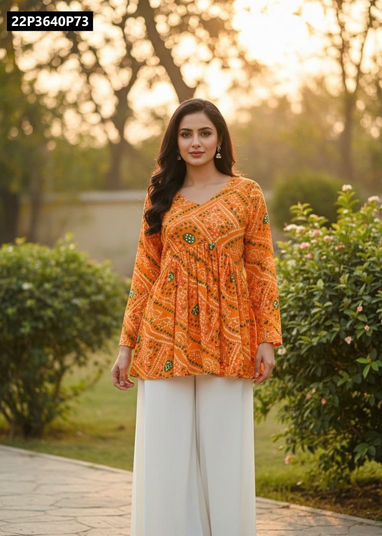 Model wearing a vibrant orange TRENDBUY Pure Georgette Bandhani print peplum tunic top with white palazzo pants, posing elegantly in a sunny garden setting.