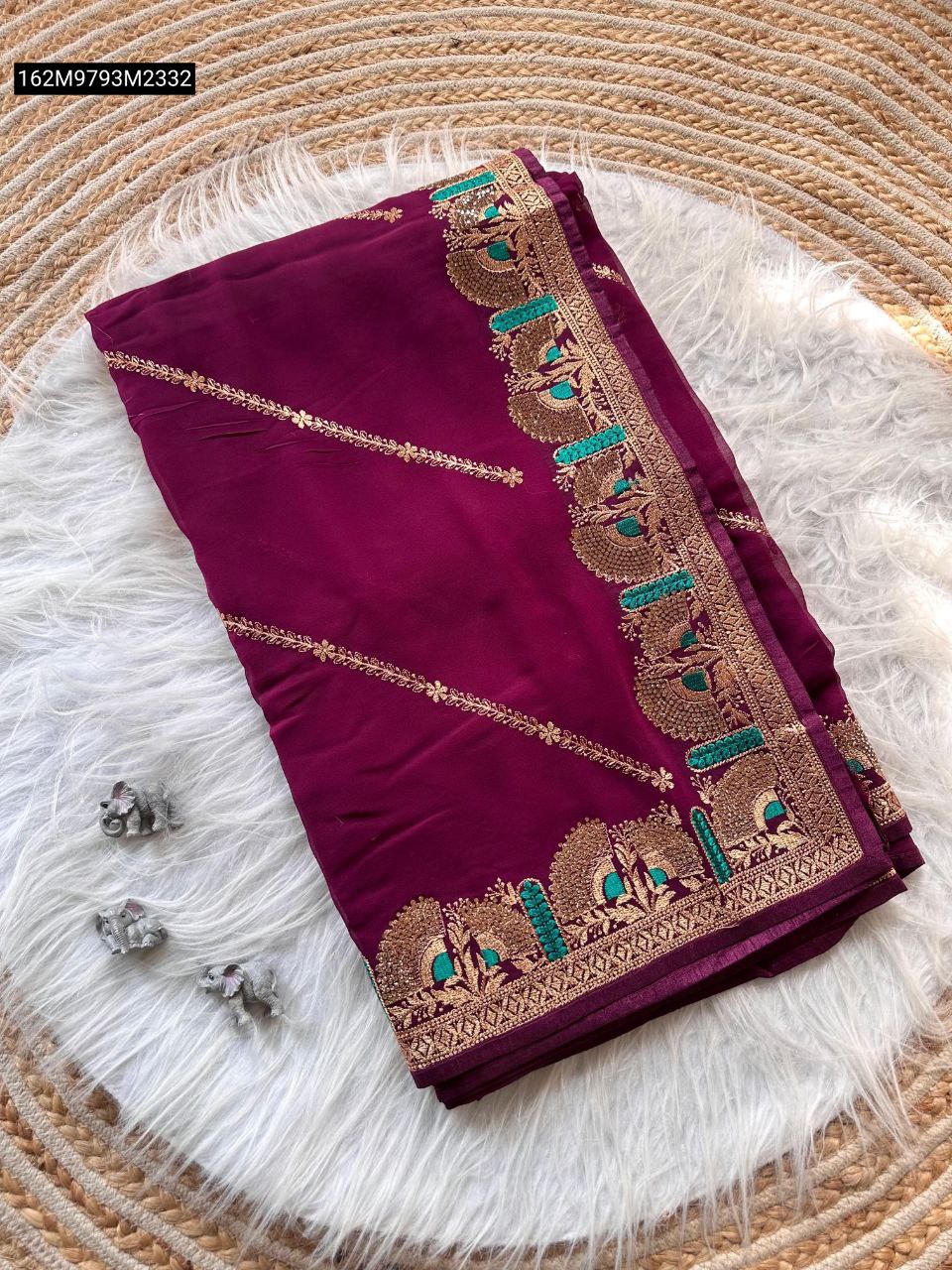 Neatly folded TRENDBUY Pure Georgette Saree in a rich maroon color, highlighting the detailed Zari and Meenakari border with peacock patterns.