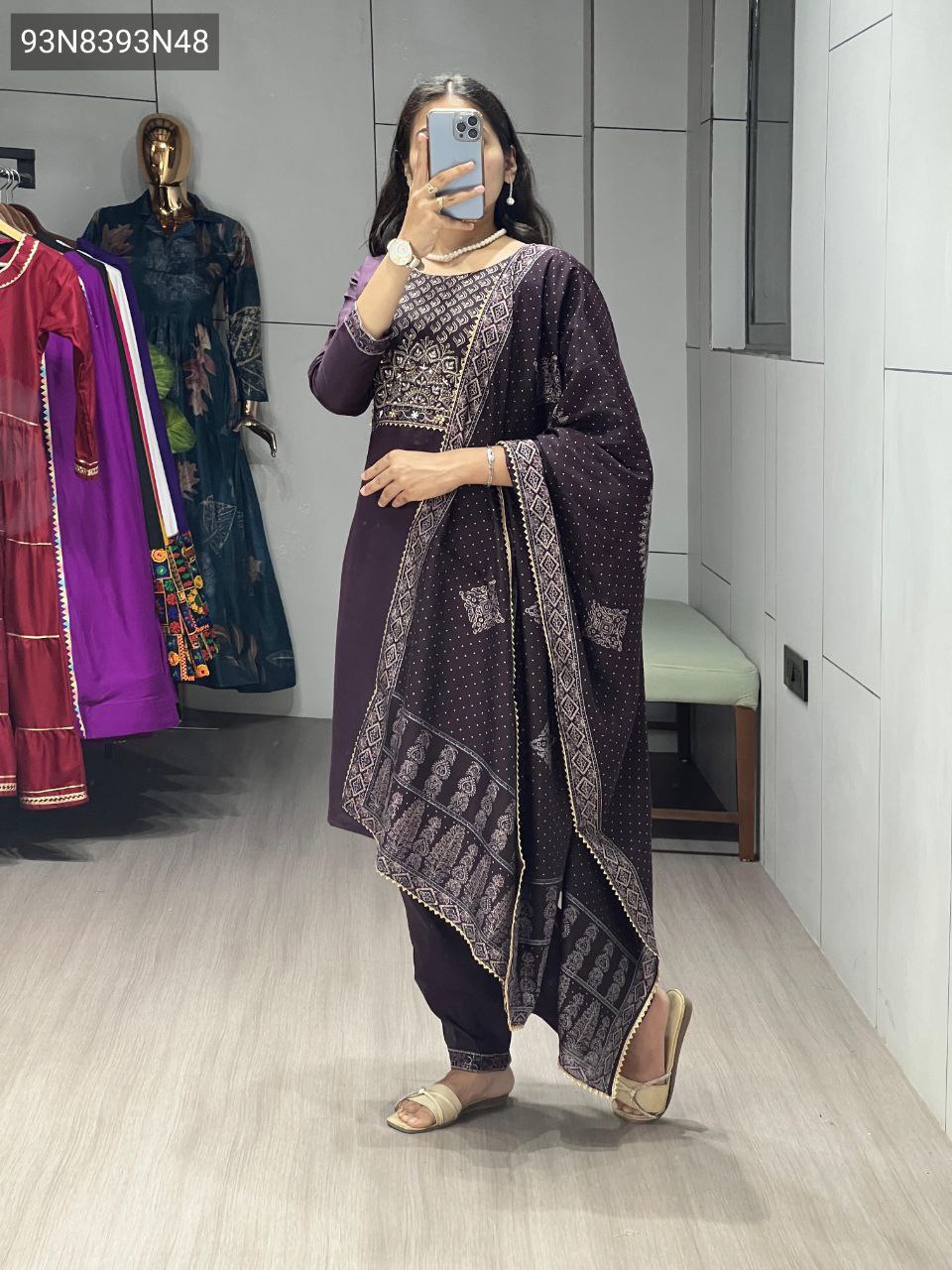 TRENDBUY Plum Modal Chanderi kurti set with intricate foil print and handwork on the yoke, paired with matching pants and a printed dupatta, worn by a model indoors with gold sandals.