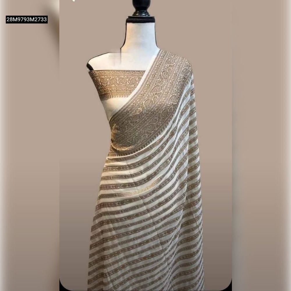 TRENDBUY Cream Khadi Georgette Silk Saree, elegantly draped on a mannequin, showcasing intricate gold zari woven stripes and a rich pallu design.